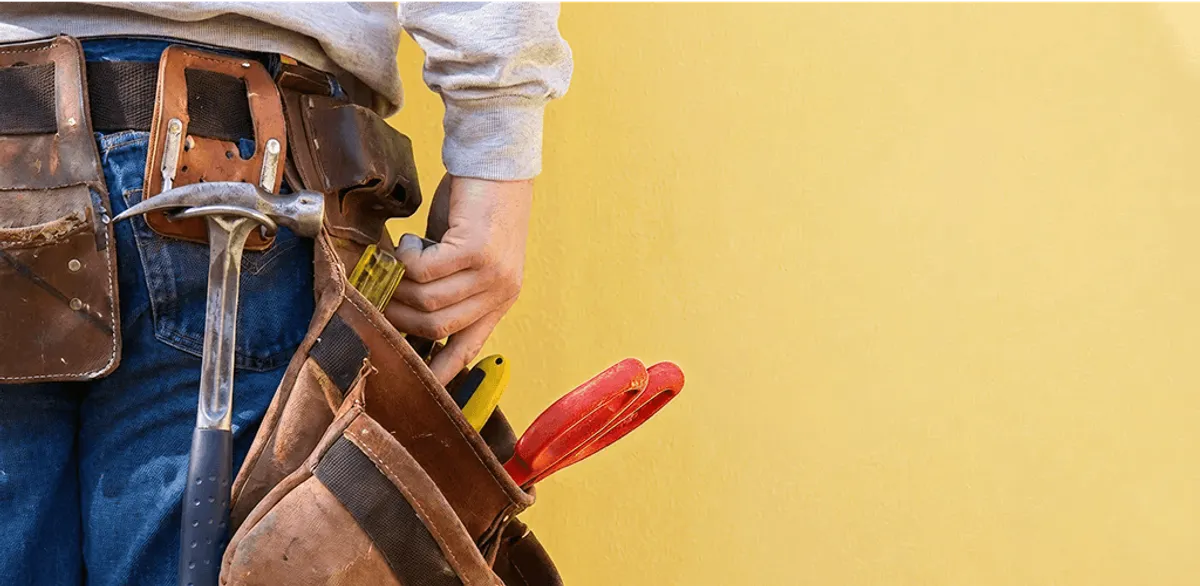 Handyman with tool belt ready for home repairs and maintenance in Reno, NV